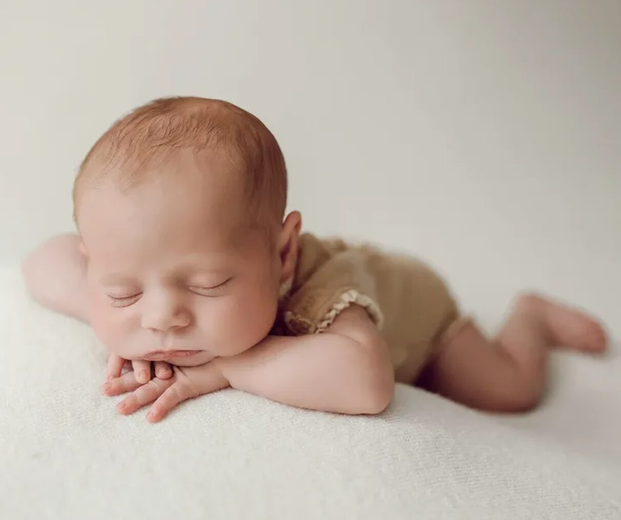 Neugeborenenshooting – Baby auf dem Bauch, sanftes Licht